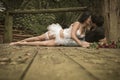 Young attractive couple kissing on wooden deck in forest Royalty Free Stock Photo