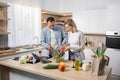 Young attractive couple in love preparing salad from fresh vegetables. Royalty Free Stock Photo