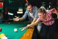 Young couple playing snooker together in bar Royalty Free Stock Photo