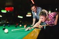Young couple playing snooker together in bar Royalty Free Stock Photo