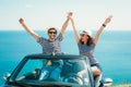 Young attractive couple posing in a convertible car