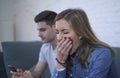 Young attractive couple in relationship problem with internet mobile phone addiction boyfriend ignoring sad neglected and bored gi Royalty Free Stock Photo