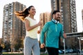 Young attractive couple running outside on sunny day Royalty Free Stock Photo