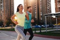 Young attractive couple running outside on sunny day Royalty Free Stock Photo