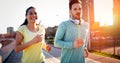 Young attractive couple running outside on sunny day Royalty Free Stock Photo