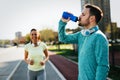 Young attractive couple running outside on sunny day Royalty Free Stock Photo