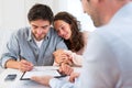 Young attractive couple signing contract Royalty Free Stock Photo