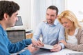 Young attractive couple signing contract Royalty Free Stock Photo