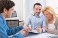 Young attractive couple signing contract Royalty Free Stock Photo