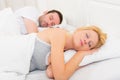 Young attractive couple sleeping in a bed Royalty Free Stock Photo