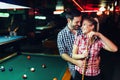 Young attractive couple on date in snooker club