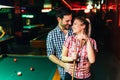 Young attractive couple on date in snooker club