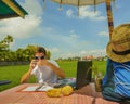 Young attractive digital nomad man working on line outdoors with laptop computer and mobile phone as freelancer and independent jo Royalty Free Stock Photo