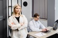 A young attractive doctor is having a consultation in his office. The doctor is making notes on the laptop, and the patient is Royalty Free Stock Photo