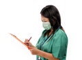 Young attractive and efficient Asian Chinese medicine doctor woman or hospital nurse in protective face mask and green gown during