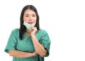 Young attractive and efficient Asian Chinese medicine doctor woman or hospital nurse in protective face mask and green gown during