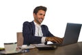 Young attractive and efficient business man working at office laptop computer desk confident in smiling happy in successful execut Royalty Free Stock Photo