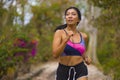 Young attractive and exotic Asian Indonesian runner woman in jogging workout outdoors at countryside road track nature running Royalty Free Stock Photo