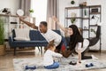 Young family african man and muslim arabic woman practising yoga stretching workout at home Royalty Free Stock Photo