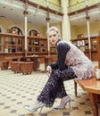 Young attractive fashion lady on railway station waiting, vintage people concept in classic interior Royalty Free Stock Photo