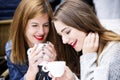 Young and attractive fashionable women are having fun at a cafe.