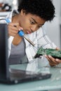 Young attractive female digital electronic engineer repairing pc Royalty Free Stock Photo