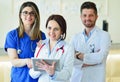 Young Attractive female doctor in front of medical group. Royalty Free Stock Photo