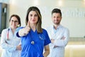 Young Attractive female doctor in front of medical group. Royalty Free Stock Photo