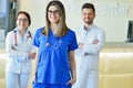 Young Attractive female doctor in front of medical group. Royalty Free Stock Photo