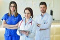 Young Attractive female doctor in front of medical group. Royalty Free Stock Photo