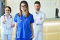 Young Attractive female doctor in front of medical group. Royalty Free Stock Photo