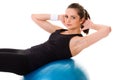 Young attractive female exercise using blue ball