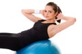 Young attractive female exercise using blue ball Royalty Free Stock Photo
