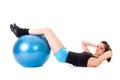 Young attractive female exercise using blue ball