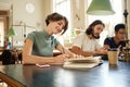 Young attractive female student with book happily working on study project in library of university Royalty Free Stock Photo