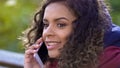 Young attractive female talking with her friend over mobile phone, closeup Royalty Free Stock Photo