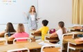 Young attractive female teacher giving lesson to children Royalty Free Stock Photo