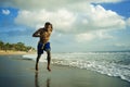 Young attractive fit athletic and strong black African American man running at the beach training hard and sprinting on sea water Royalty Free Stock Photo