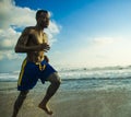 Young attractive fit athletic and strong black African American man running at the beach training hard and sprinting on sea water Royalty Free Stock Photo