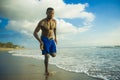 Young attractive fit athletic and strong black African American man running at the beach training hard and sprinting on sea water Royalty Free Stock Photo