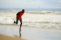 Young attractive fit athletic and strong black African American man running at the beach training hard and sprinting on sea water Royalty Free Stock Photo