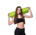 Young attractive fitness woman ready for workout holding green yoga mat isolated on white background. Royalty Free Stock Photo