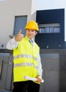 Young attractive foreman worker supervising building blueprints outdoors wearing construction helmet Royalty Free Stock Photo