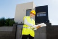 Young attractive foreman worker supervising building blueprints smiling happy outdoors Royalty Free Stock Photo