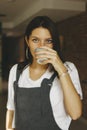 Young attractive girl in casual clothes drinking coffee in cafe Royalty Free Stock Photo