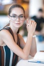 Young attractive girl in glasses in cafe Royalty Free Stock Photo