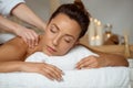 Young attractive girl having massage relaxing in spa salon. Royalty Free Stock Photo