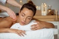 Young attractive girl having massage relaxing in spa salon. Royalty Free Stock Photo
