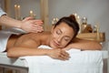 Young attractive girl having massage relaxing in spa salon. Royalty Free Stock Photo