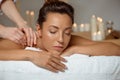 Young attractive girl having massage relaxing in spa salon. Royalty Free Stock Photo